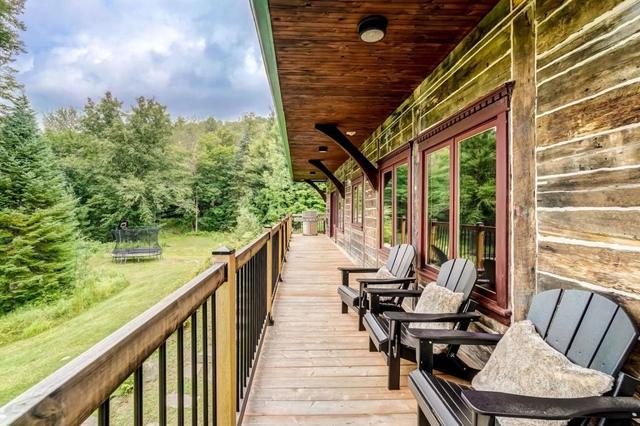 The log-walled deck with chairs in summer