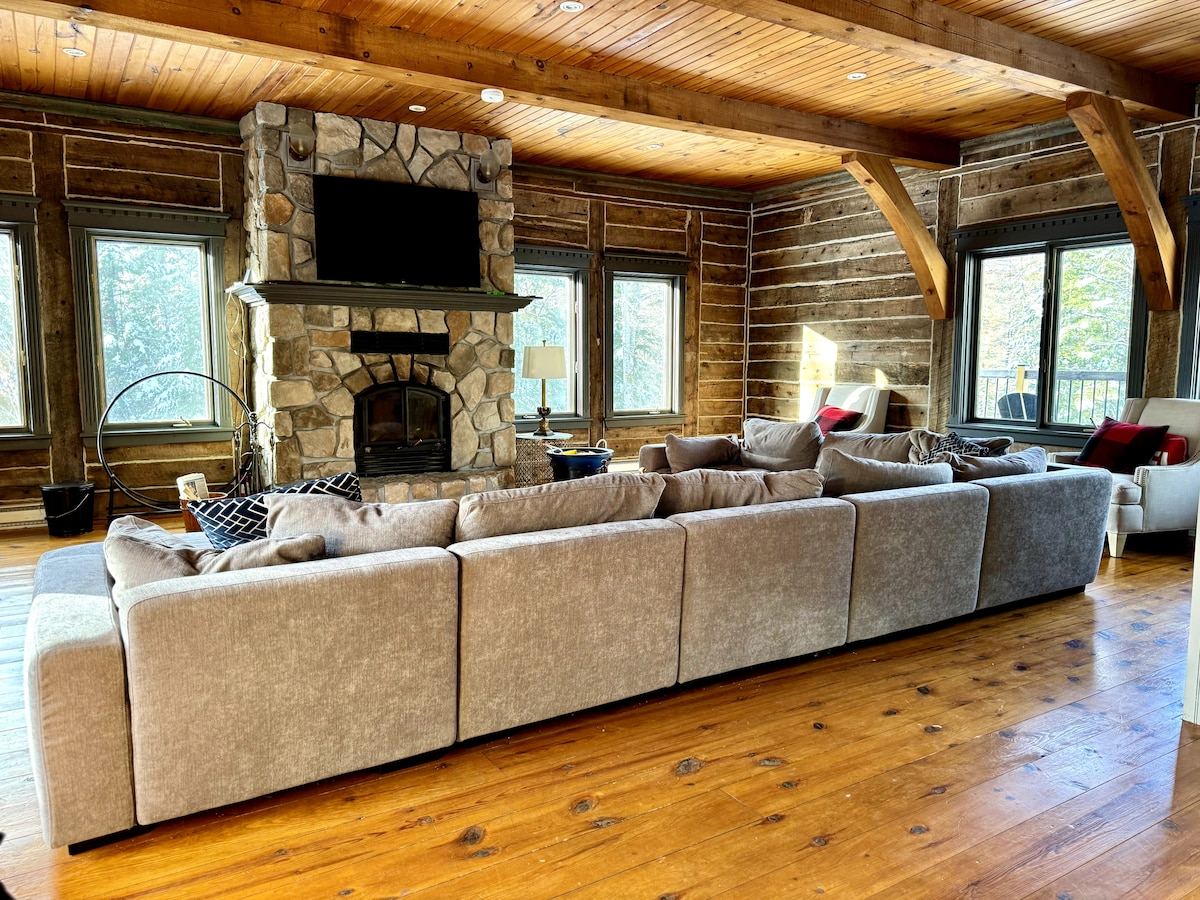 The great room's sectional sofa facing the stone fireplace and television
