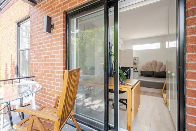 Balcony chairs beside the sliding door and brick wall