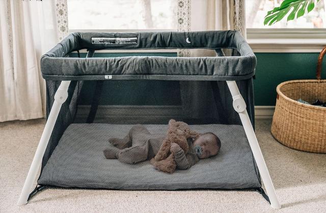 A travel crib with stuffed animals
