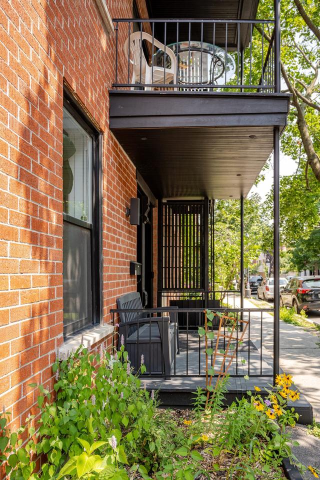 The brick facade and balcony from the street