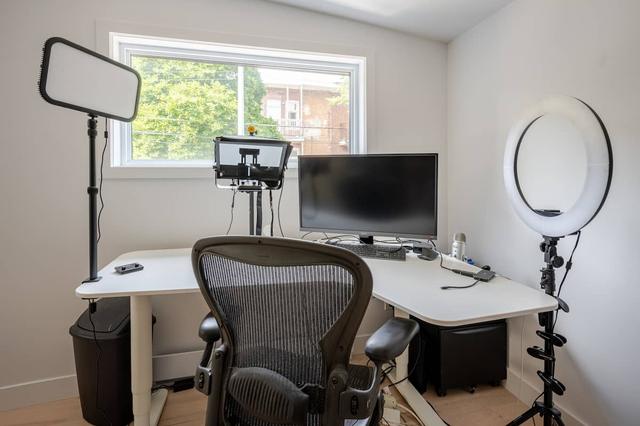 The office with desk, monitor, ergonomic chair and a window