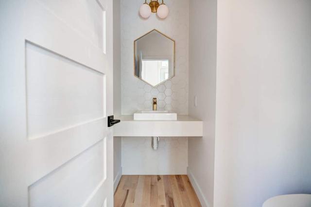 Powder room with hexagonal mirror