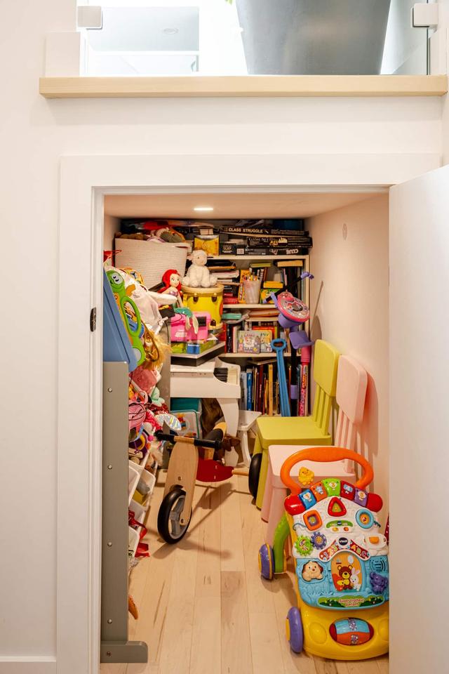 A closet stacked with children's toys and books