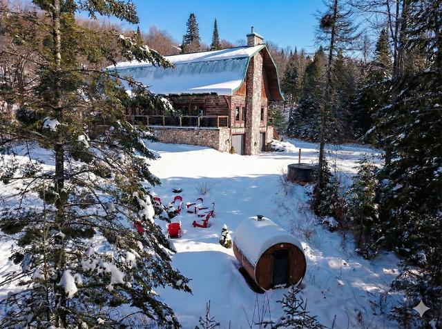 Aerial winter view of the house, barrel sauna and fire area